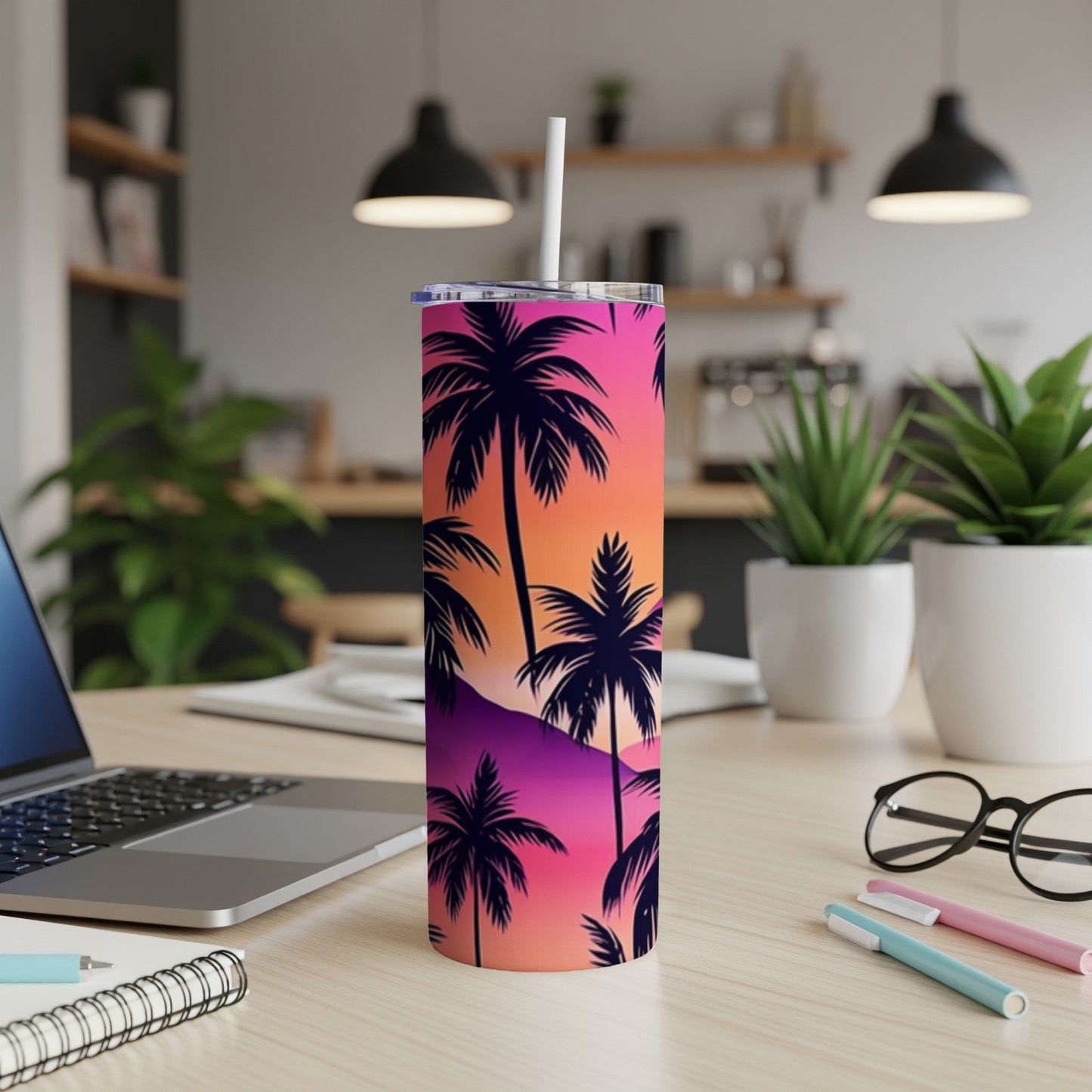 Tall tumbler with palm trees against a sunset gradient.