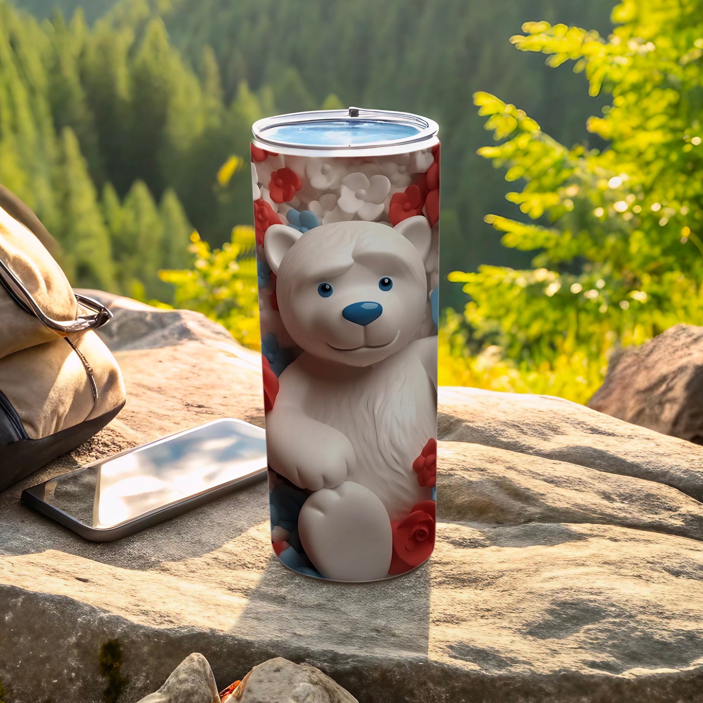 White bear with red and blue flowers on a tall blue tumbler.