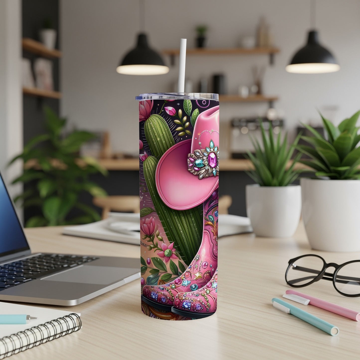 Pink cowboy hat and boots with floral accents on a tumbler.