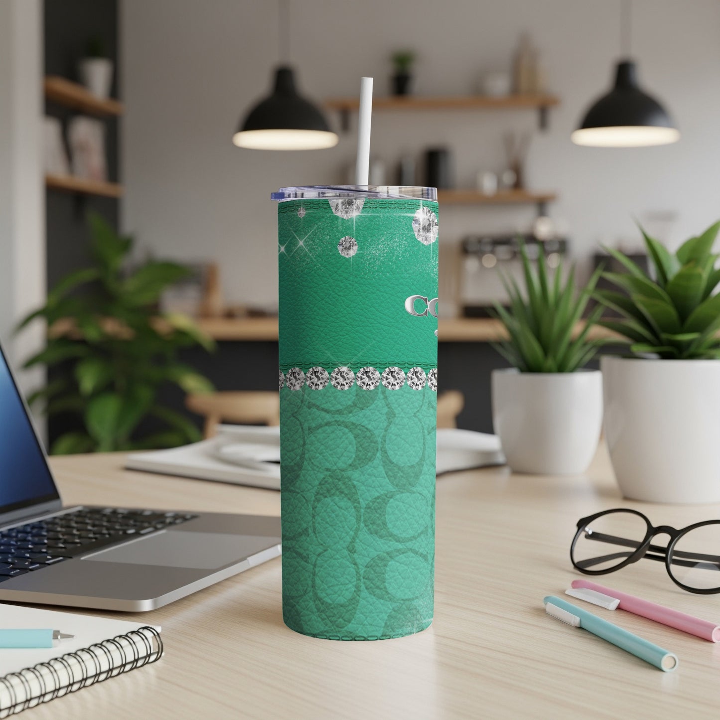 Green tumbler with diamonds and repeating logo pattern.