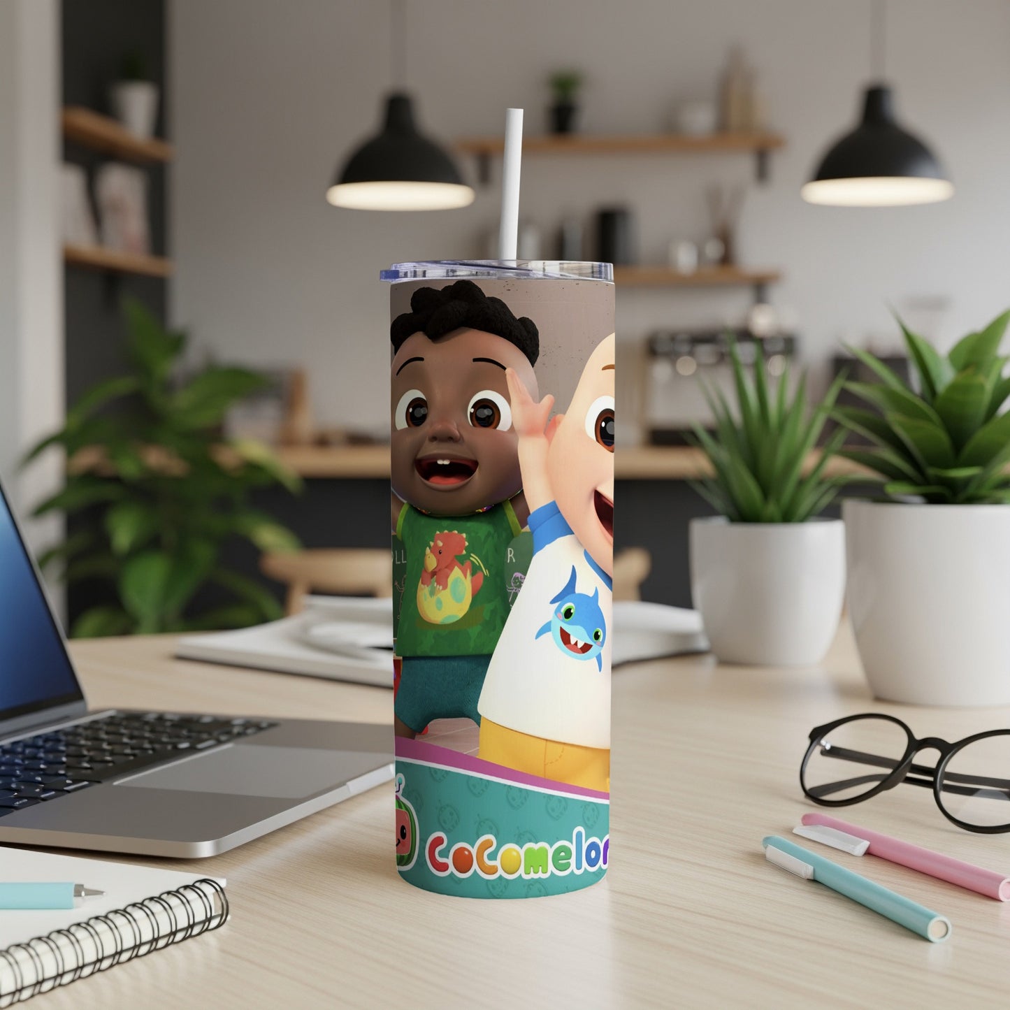 Cocomelon characters on a tumbler next to a laptop and office supplies.