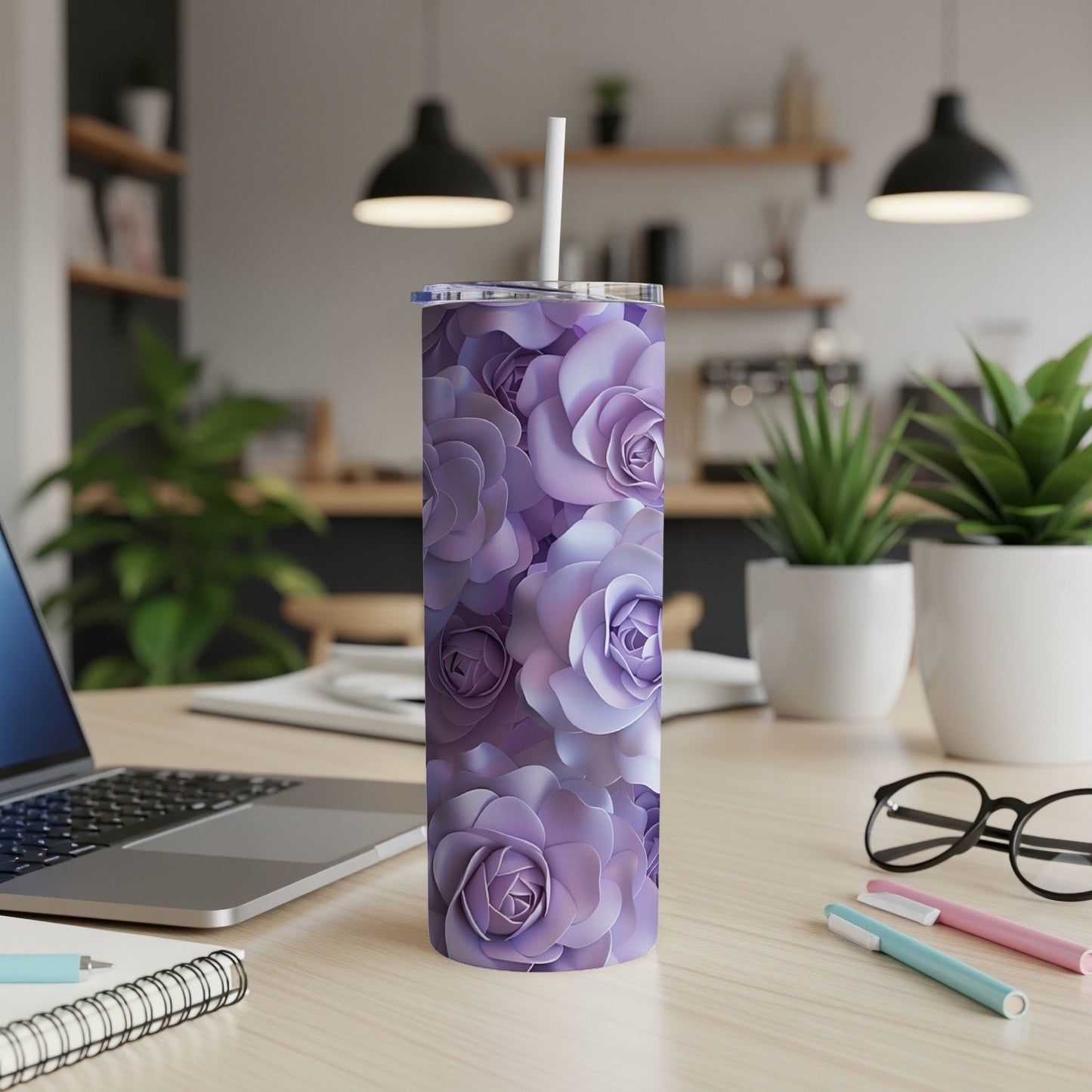 Purple floral pattern tumbler with straw on a desk.