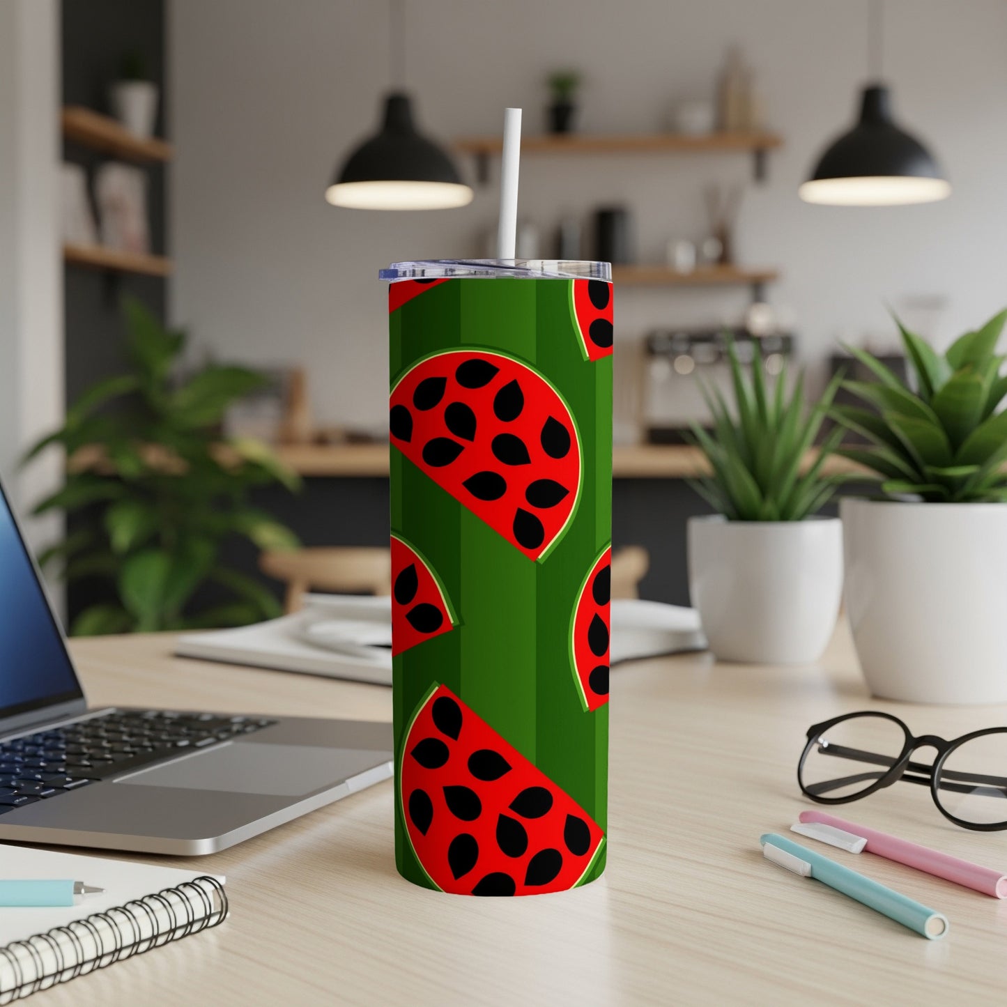 Green tumbler with repeating red watermelon slice pattern and black seeds.