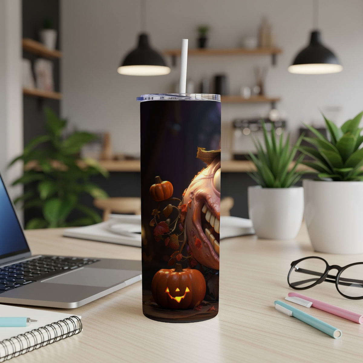 Tumbler with a spooky pumpkin face and falling leaves Halloween design.