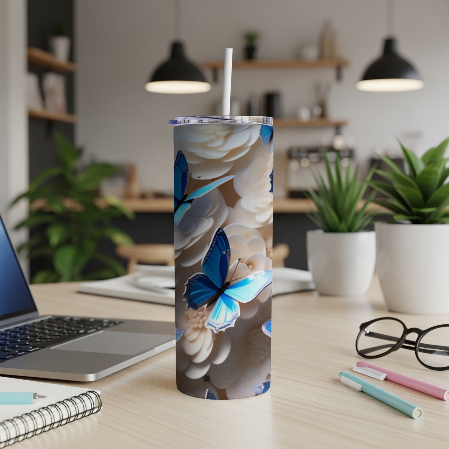 White tumbler with blue butterflies and floral pattern.