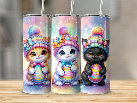 Three cartoon kittens in colorful hats holding decorated Easter eggs.