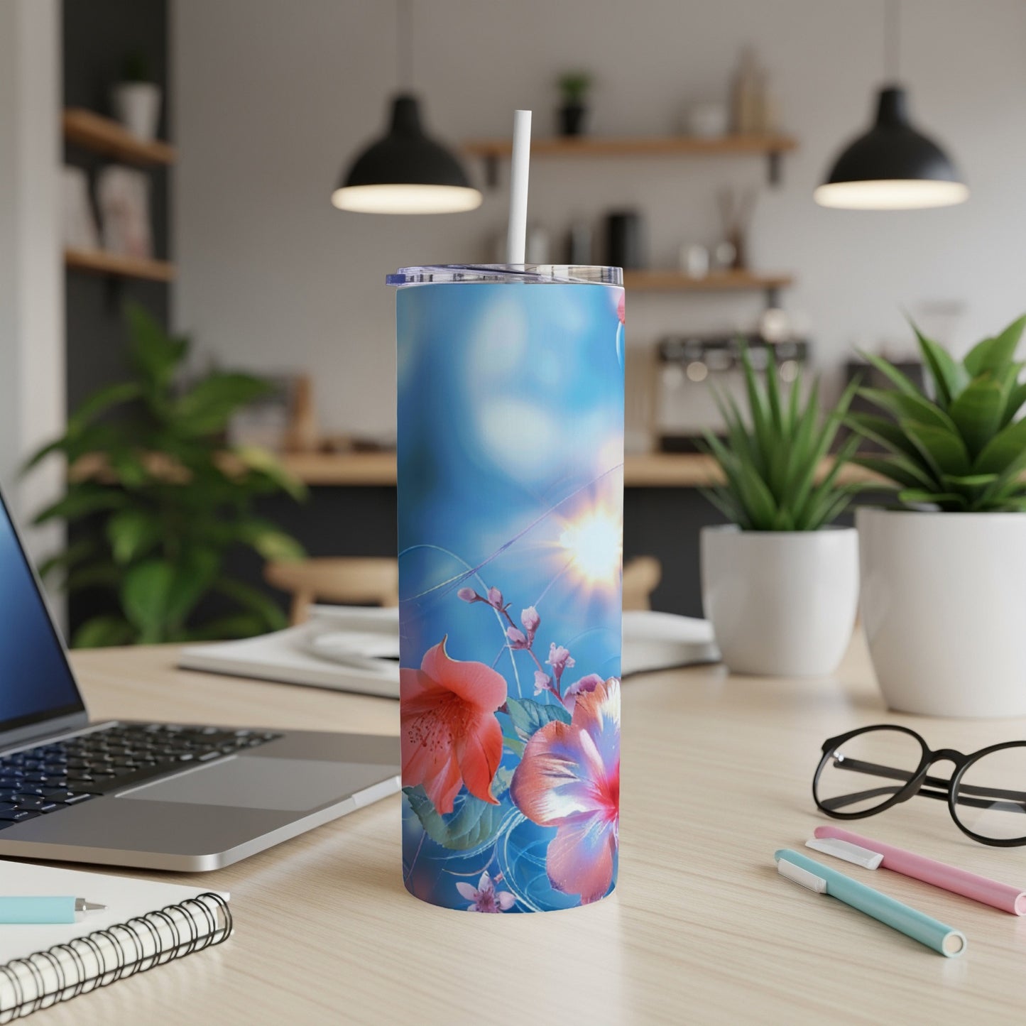 Blue tumbler with hibiscus flowers and sunlight.