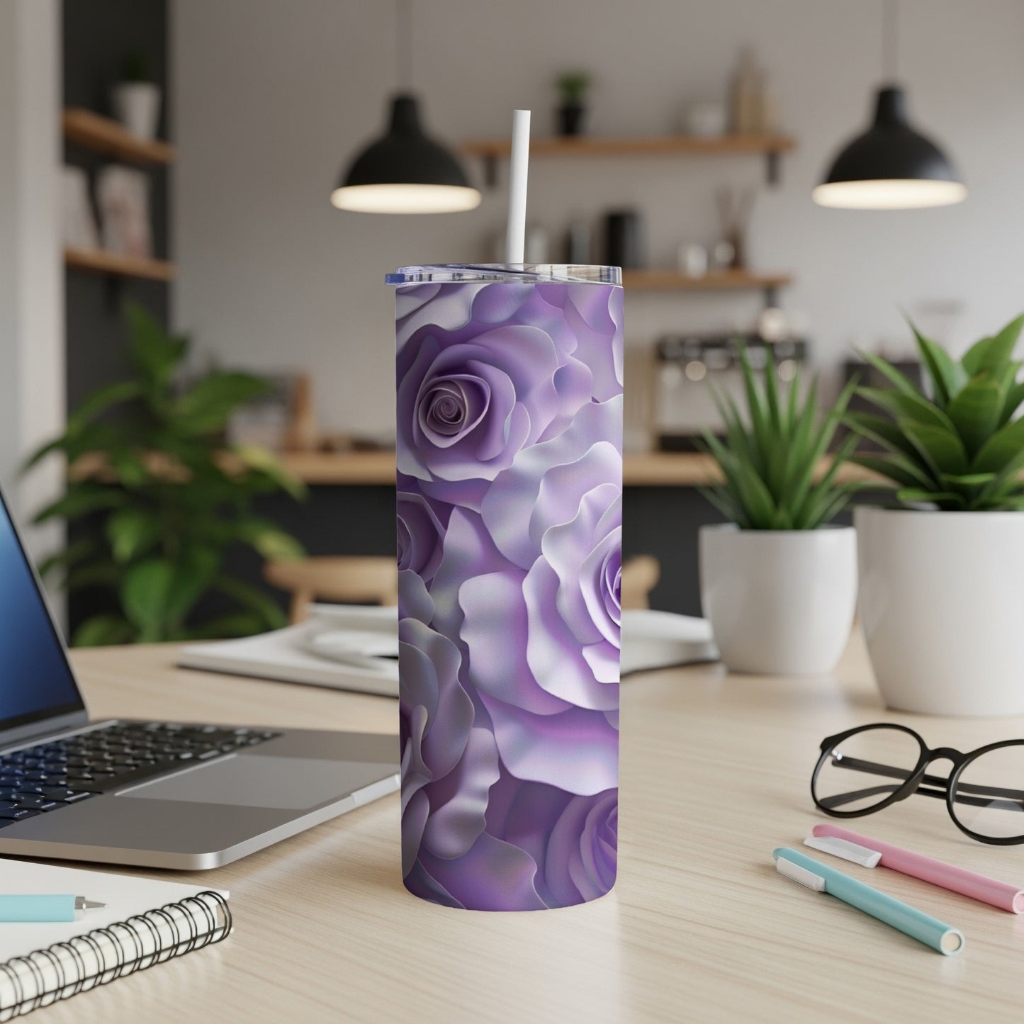 Purple floral tumbler with straw on a desk.