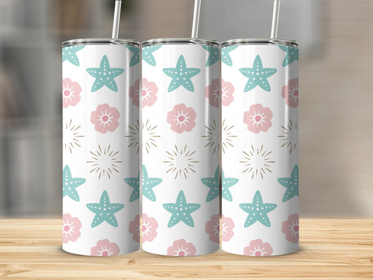 White tumbler with pink flowers and blue starfish pattern.