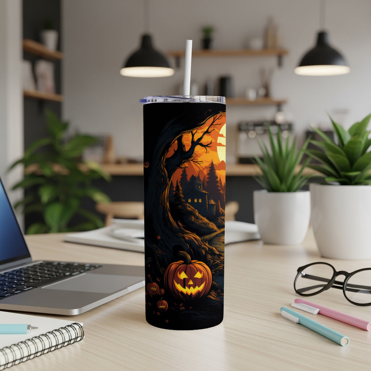 Halloween tumbler with a spooky scene featuring pumpkins and a haunted house.