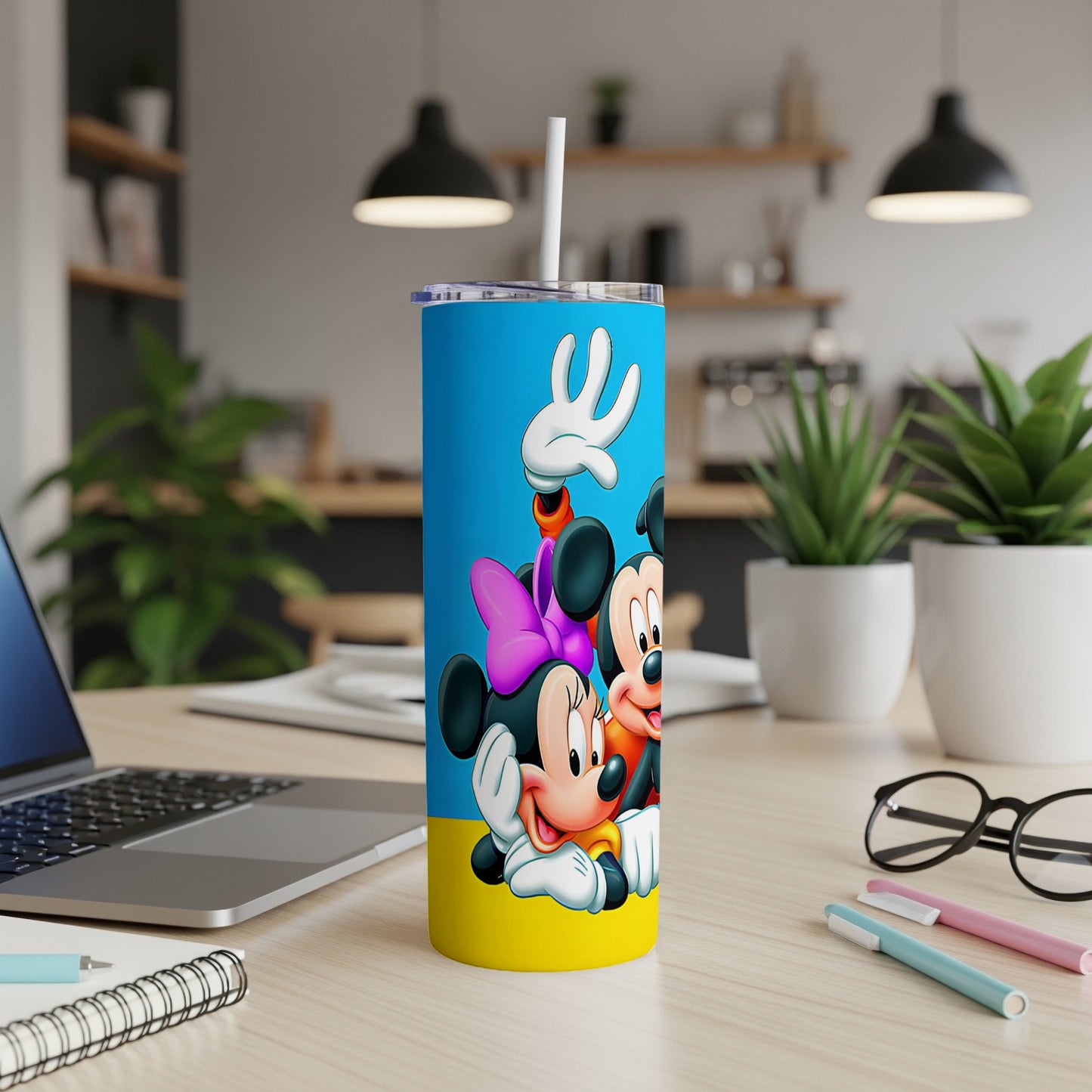 Blue tumbler with Mickey and Minnie Mouse in front of yellow and blue background.
