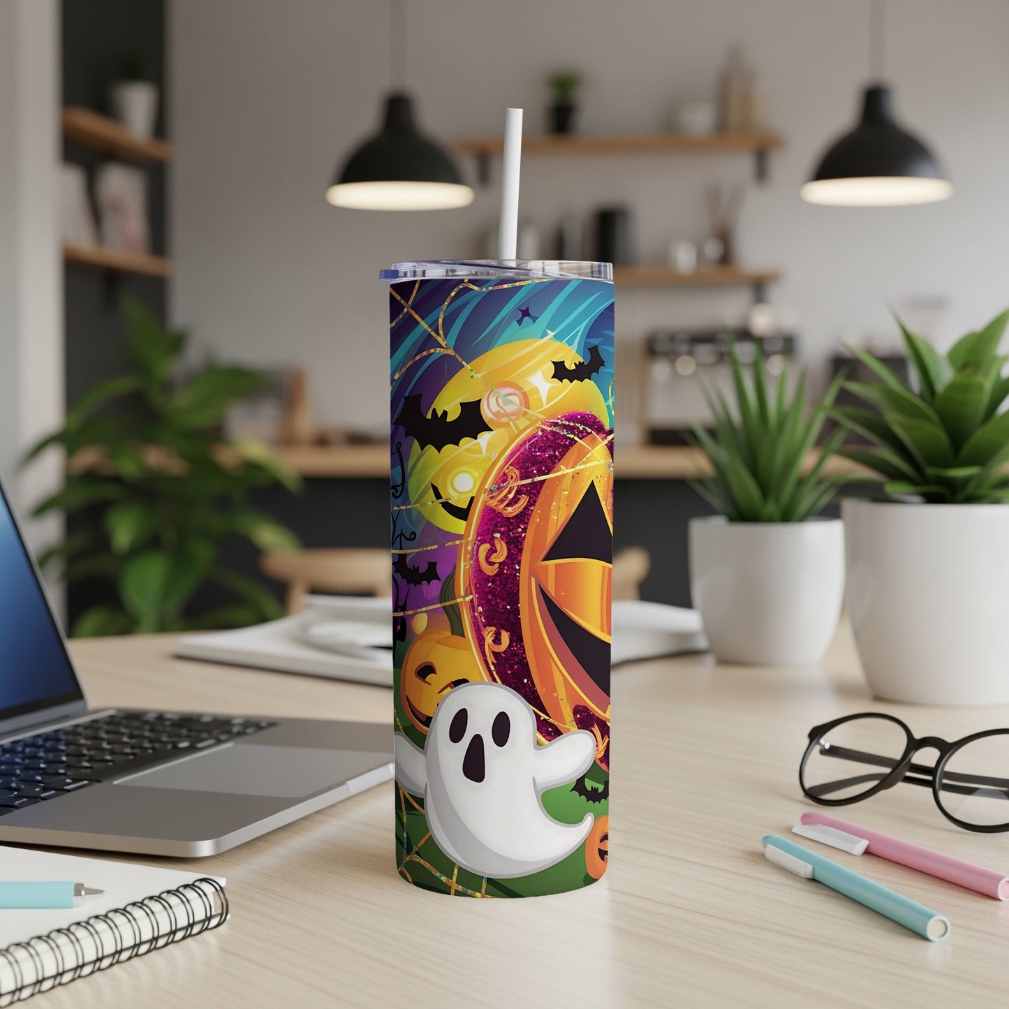 Halloween tumbler with pumpkins, bats, and a ghost on a blue background.