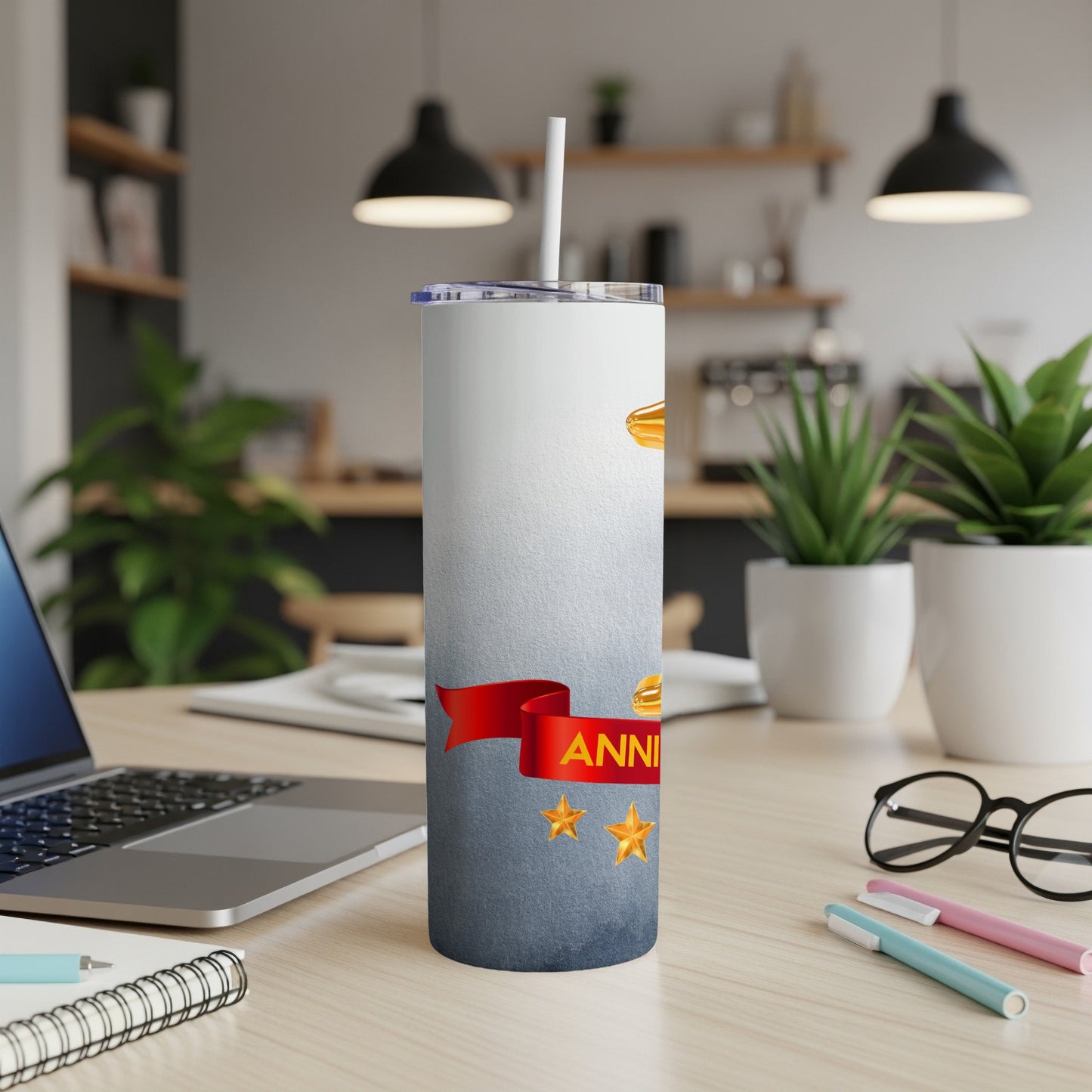 White tumbler with "ANNIVERSARY" text and gold stars on speckled background.