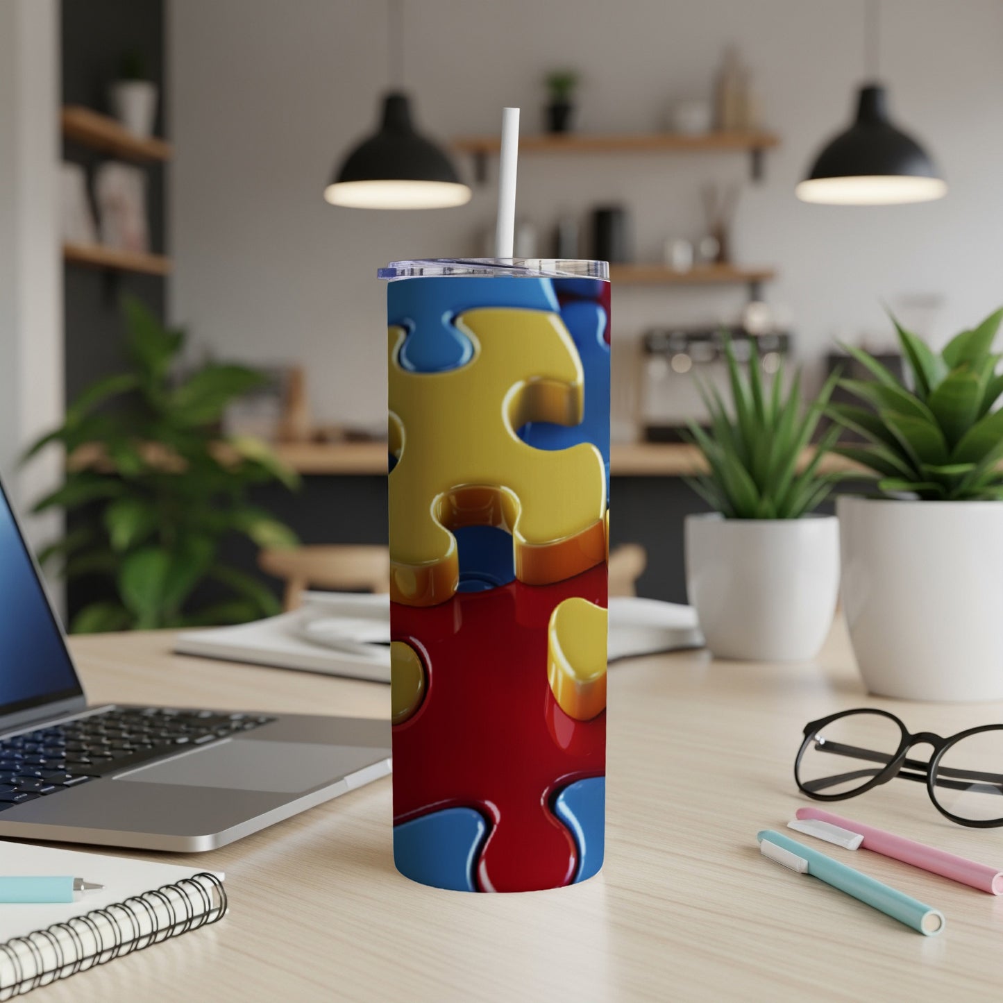Red, yellow, and blue puzzle pieces form a pattern on a stainless steel tumbler.