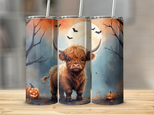 Highland cow and pumpkins on a spooky Halloween night.