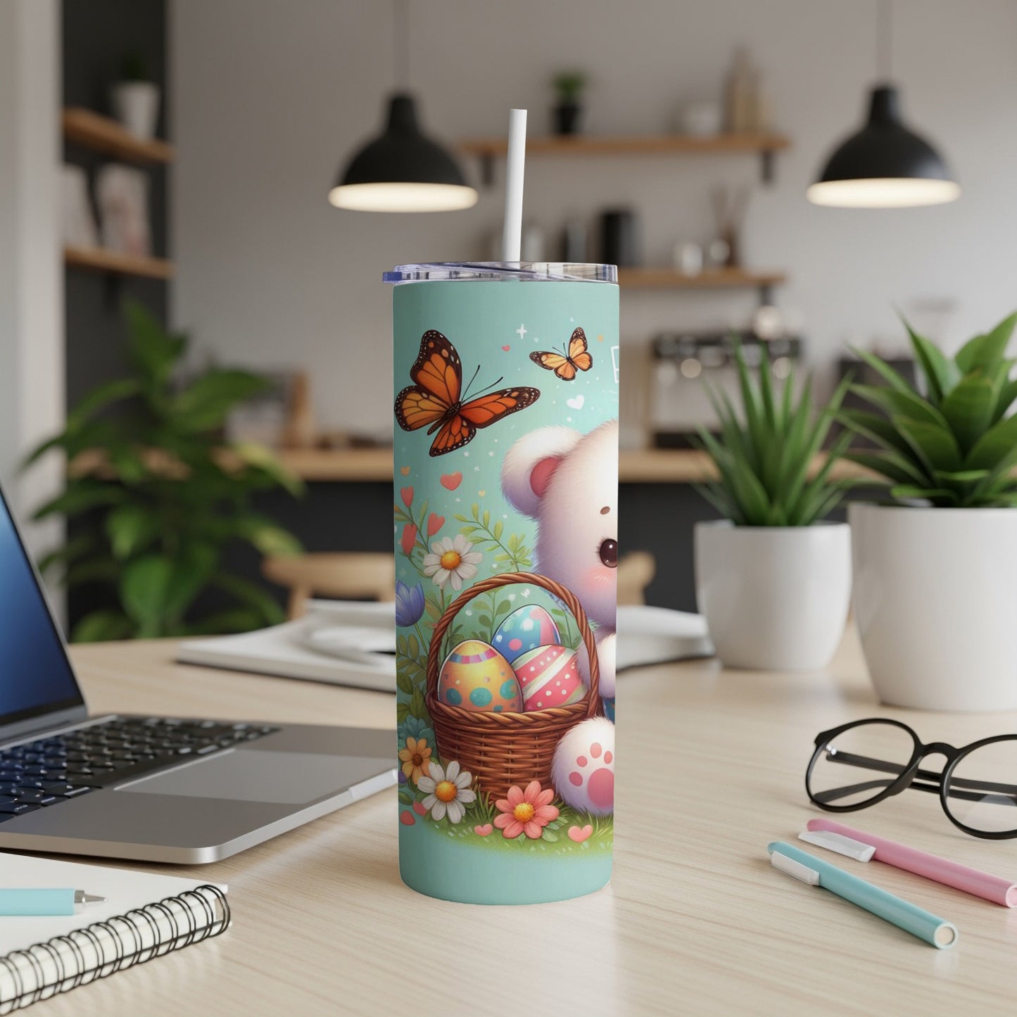 White bear in easter basket with butterflies and flowers on a teal tumbler.