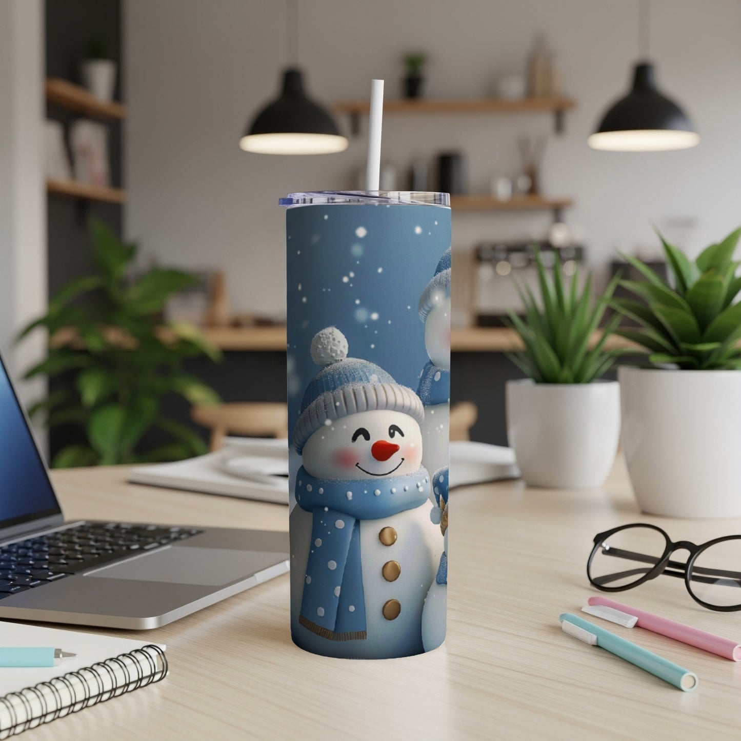 Tall tumbler with a blue snowman and snowflakes design.