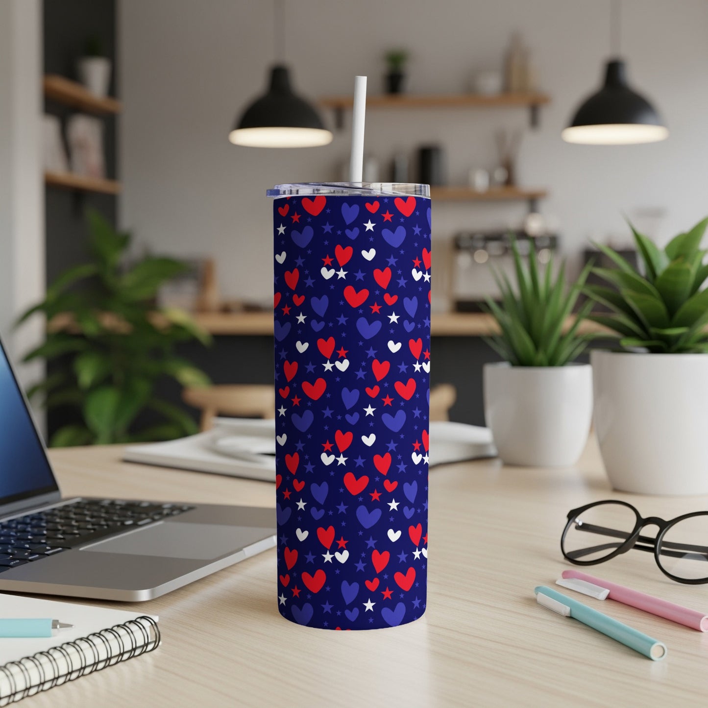 Blue tumbler with red hearts and white stars, lid and straw.