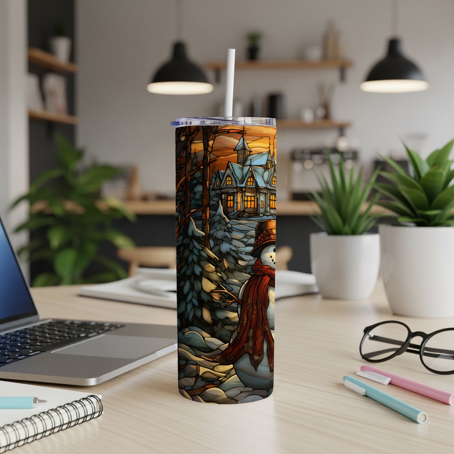 Tumbler with snowman, cozy house, and winter scene artwork.