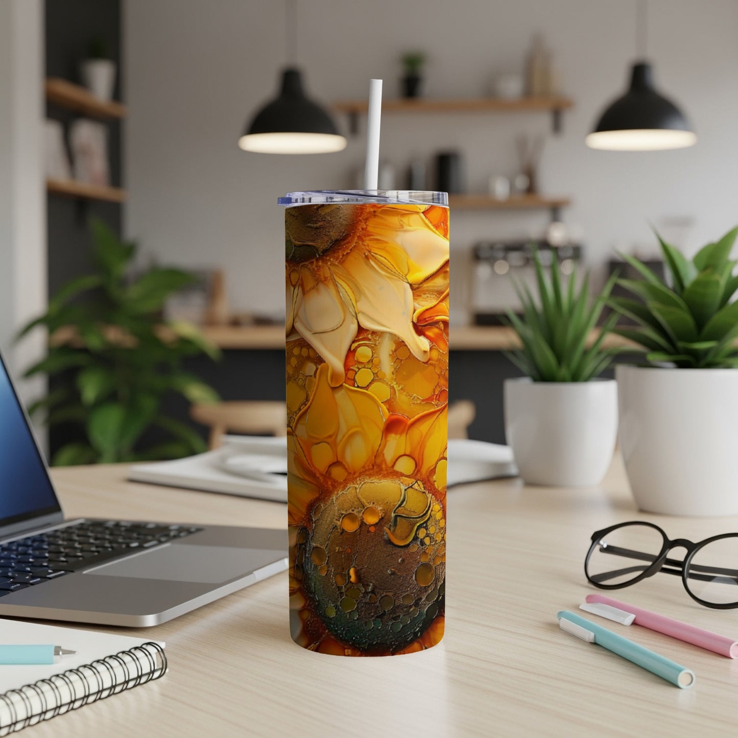 Sunflower tumbler with colorful marbled pattern on a desk.