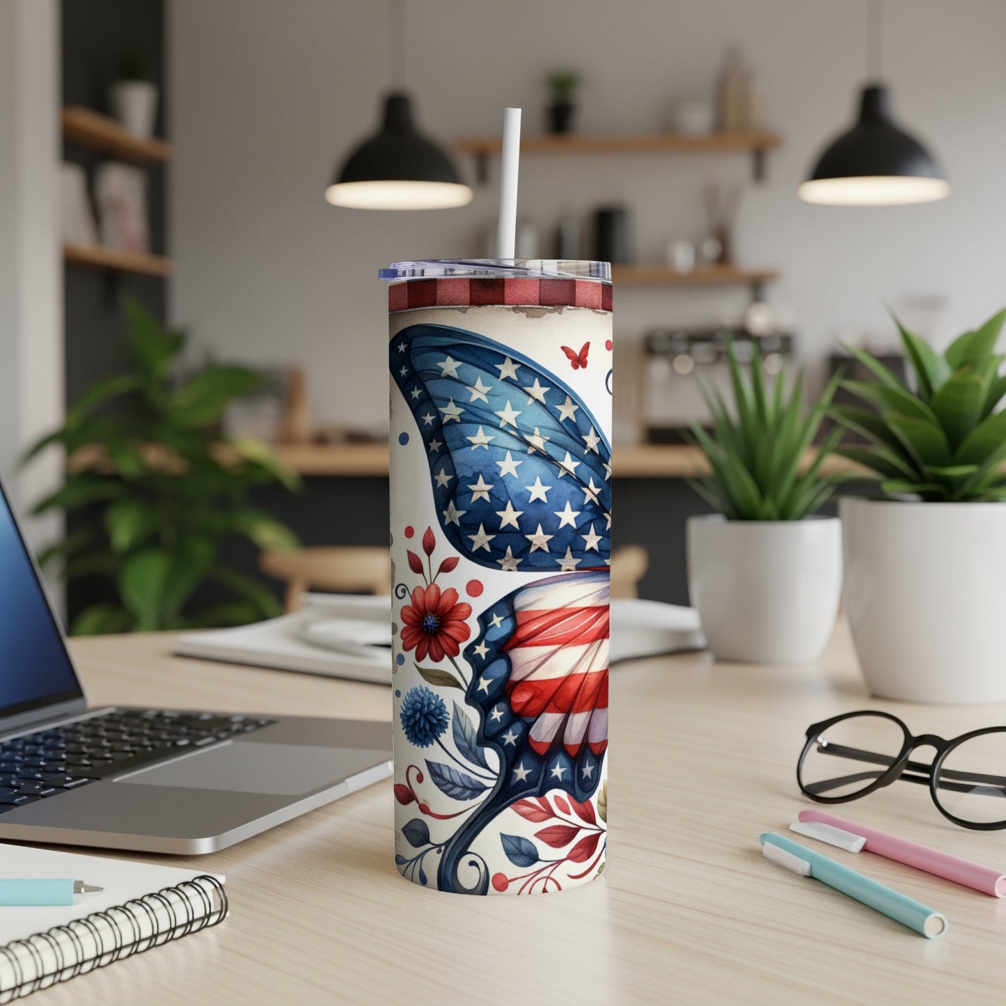 American flag butterfly design on a white tumbler with a straw.