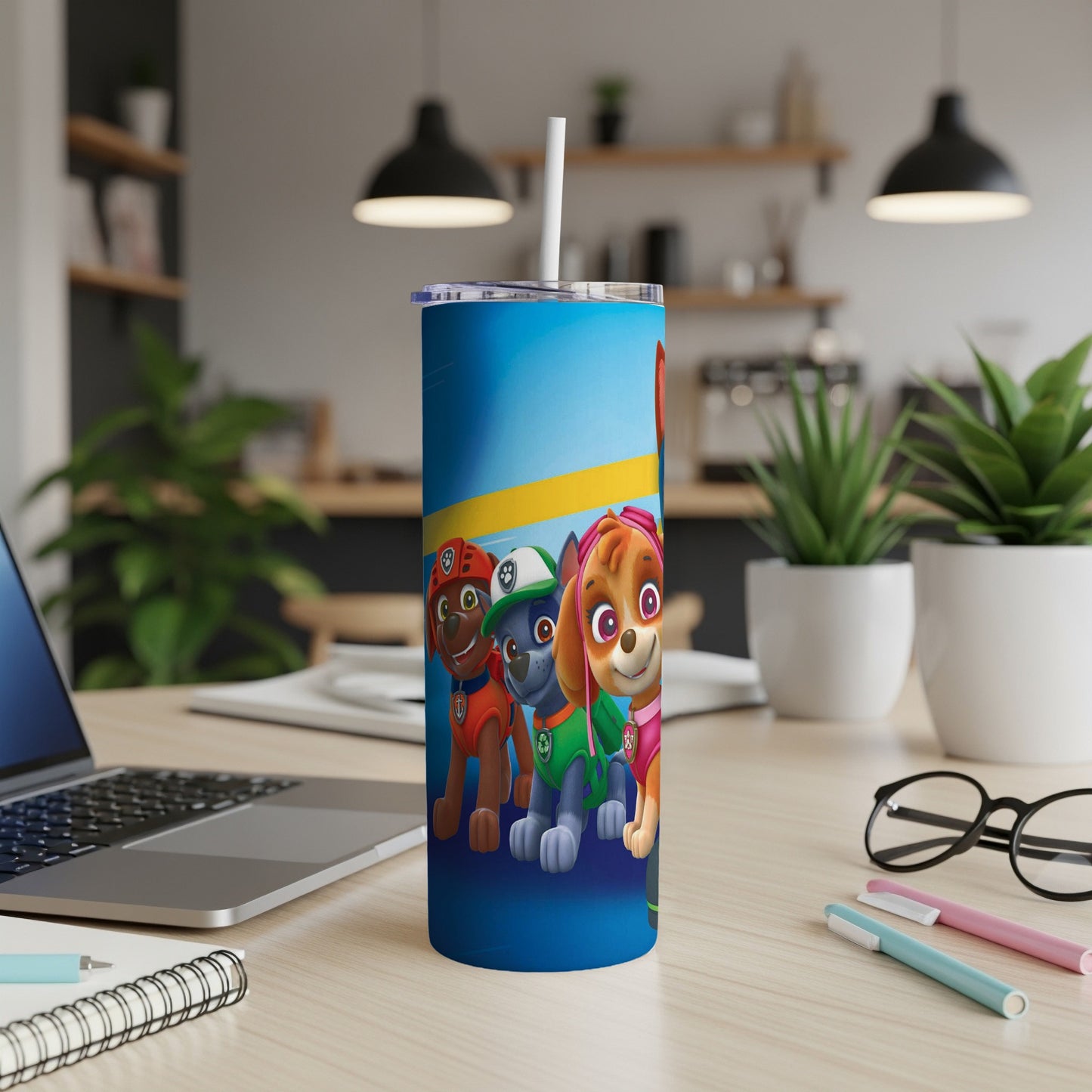 Paw Patrol characters Chase, Marshall, and Skye on a blue tumbler with a straw.