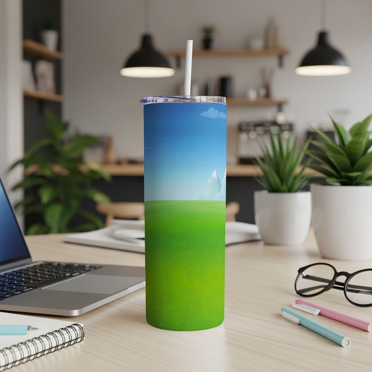 Green grassy field and blue sky on a skinny tumbler with a straw.