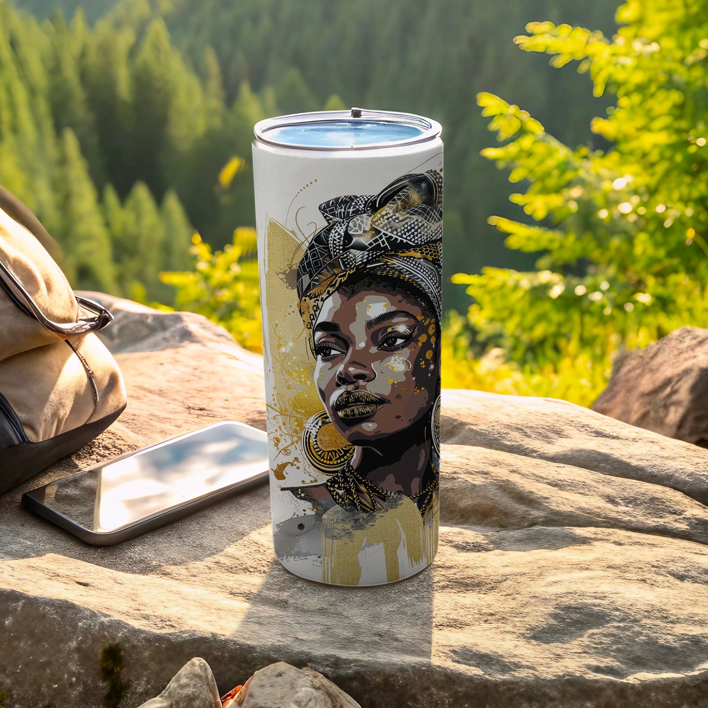 Tumbler with a gold and black portrait of a woman's face.