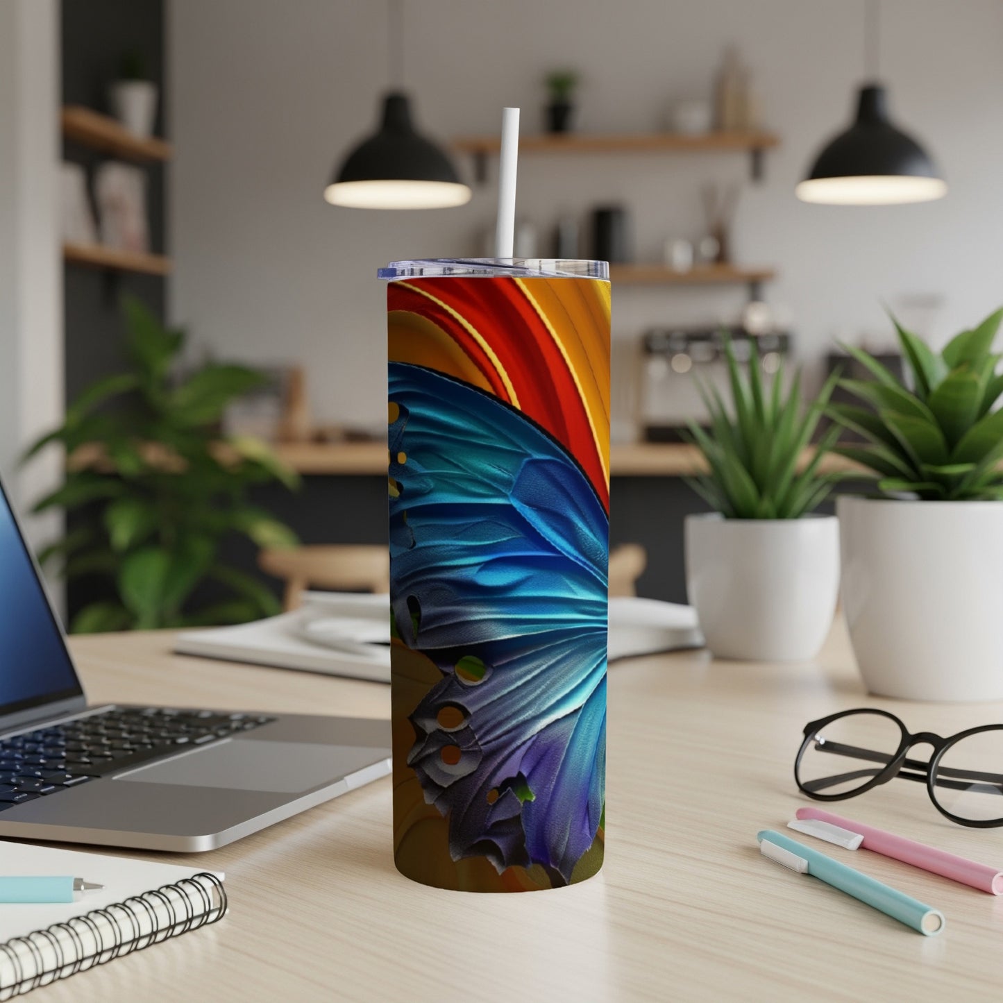 Blue and orange butterfly wing design on a tall, slender tumbler.