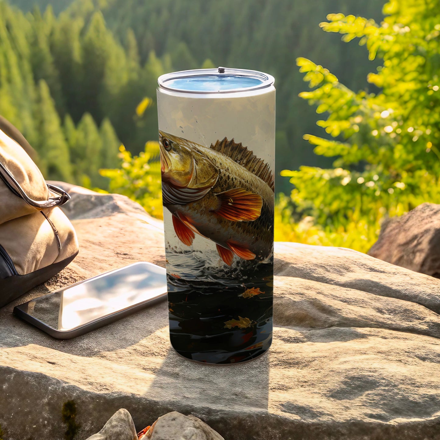 Tall tumbler with a leaping bass design, outdoors scene.