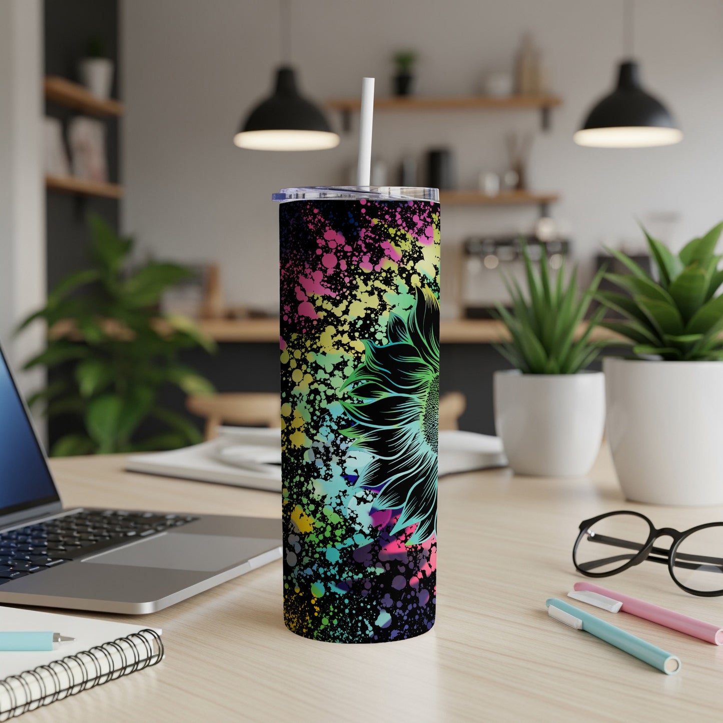 Tall tumbler with black background, colorful splatter, and a neon sunflower design.