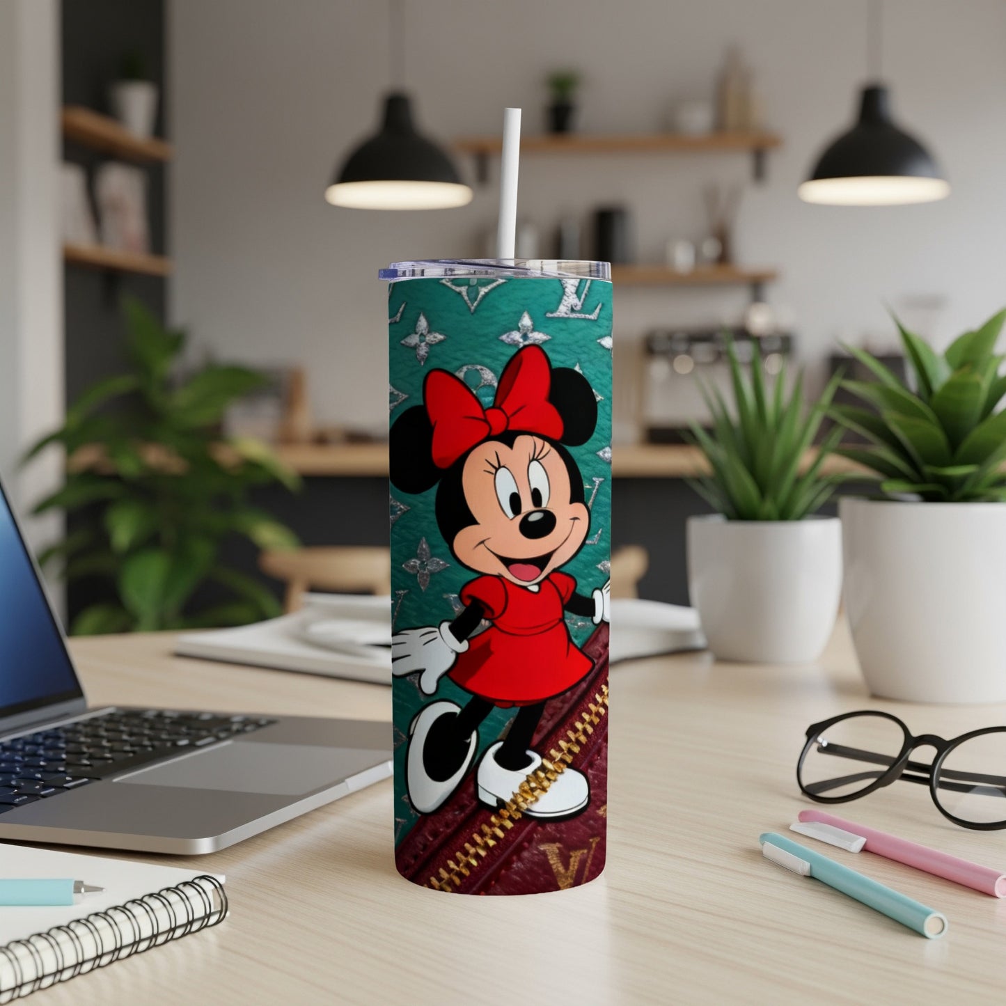 Minnie Mouse on a teal tumbler with designer pattern and red dress.