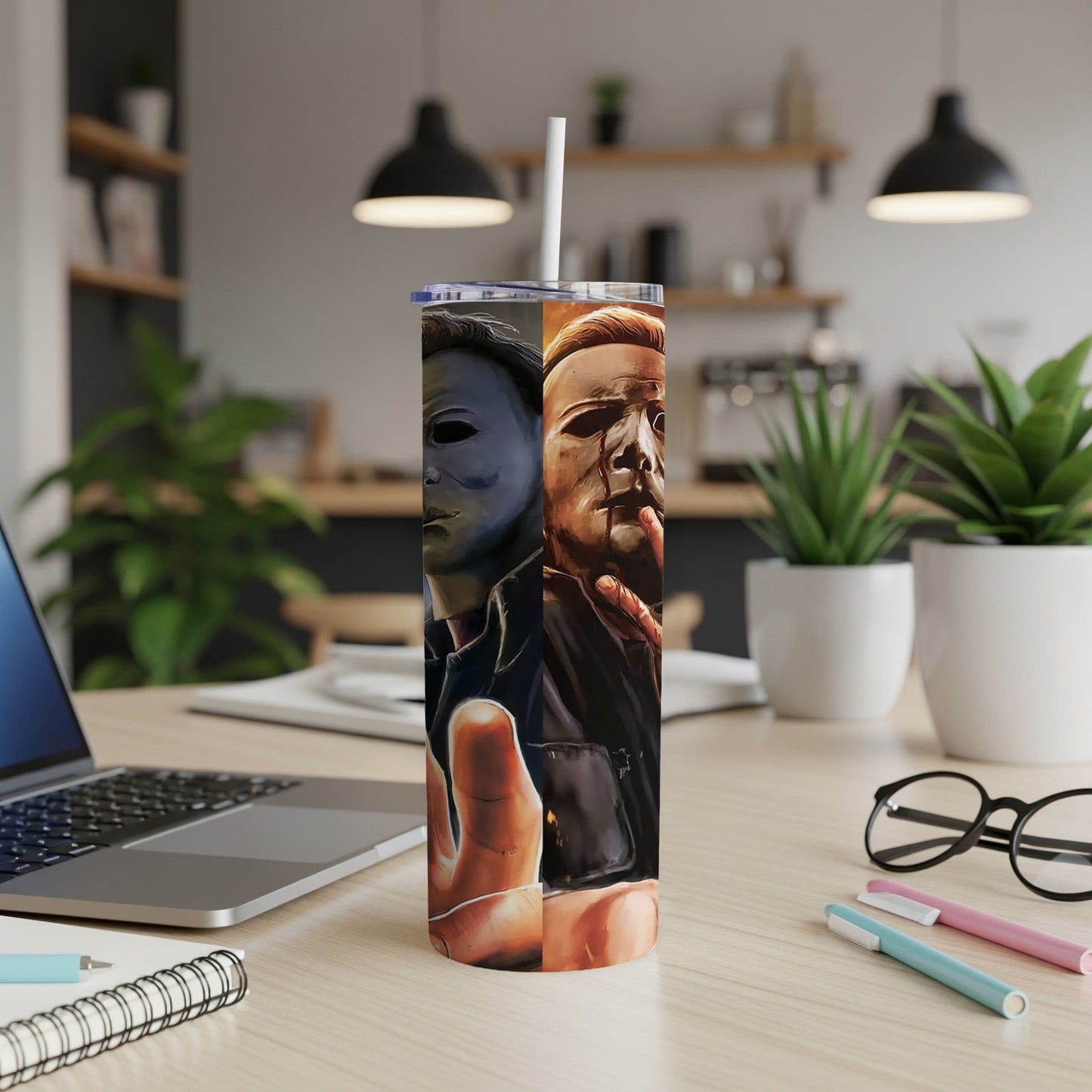 Michael Myers mask and bloody face on a tumbler with a straw.