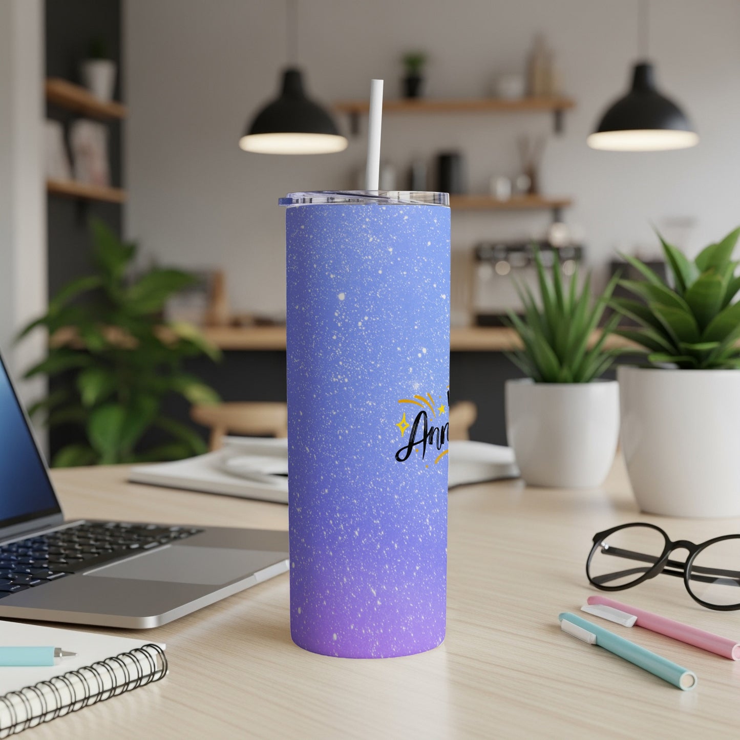 Purple and blue speckled tumbler with "Anniversary" text and a straw.