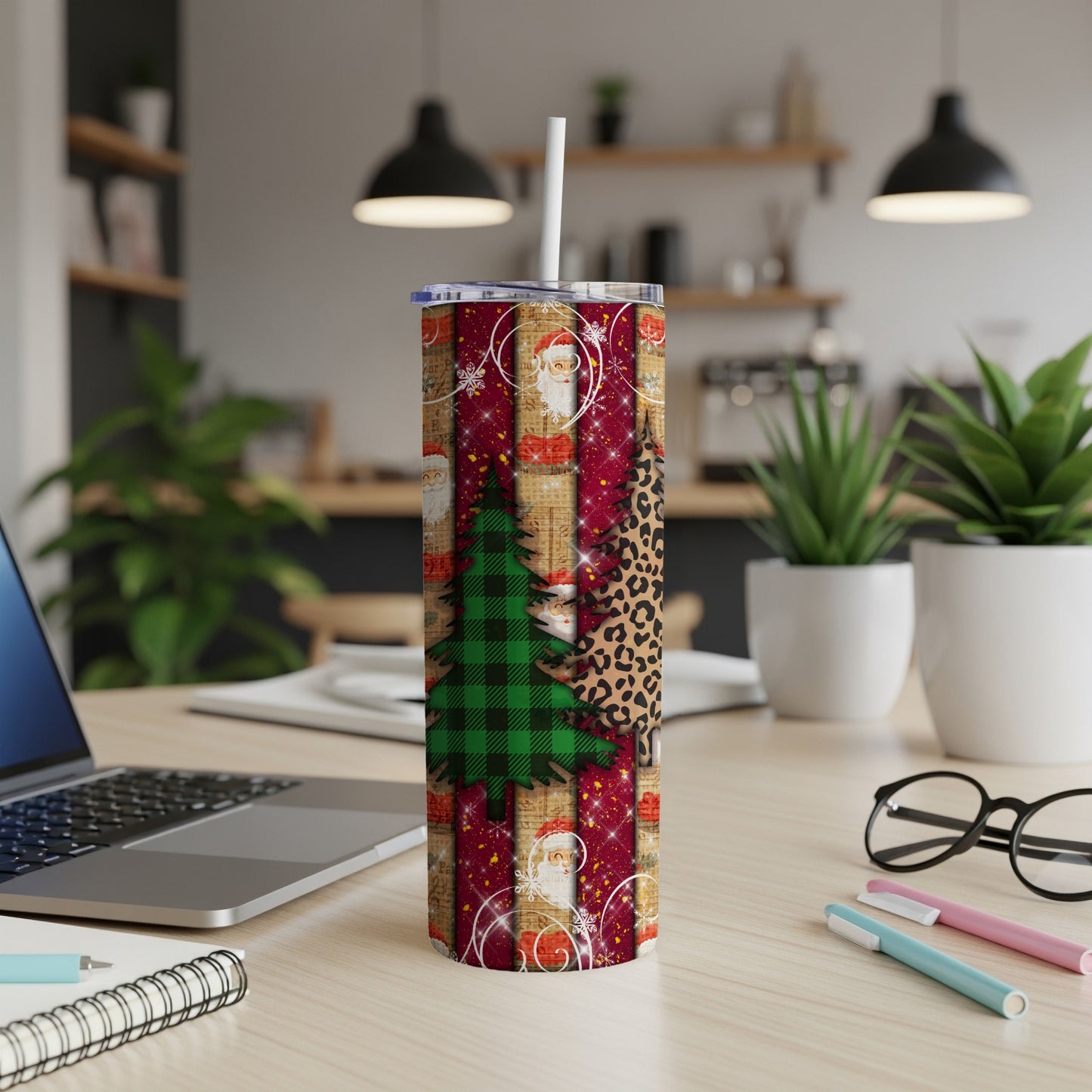 Christmas tumbler with trees, Santa, and leopard print on wooden desk.