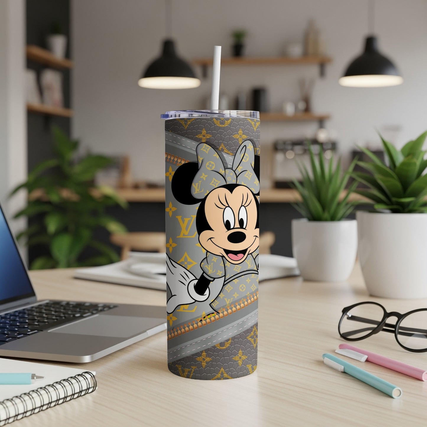 Minnie Mouse tumbler with LV pattern on desk with laptop and pens.