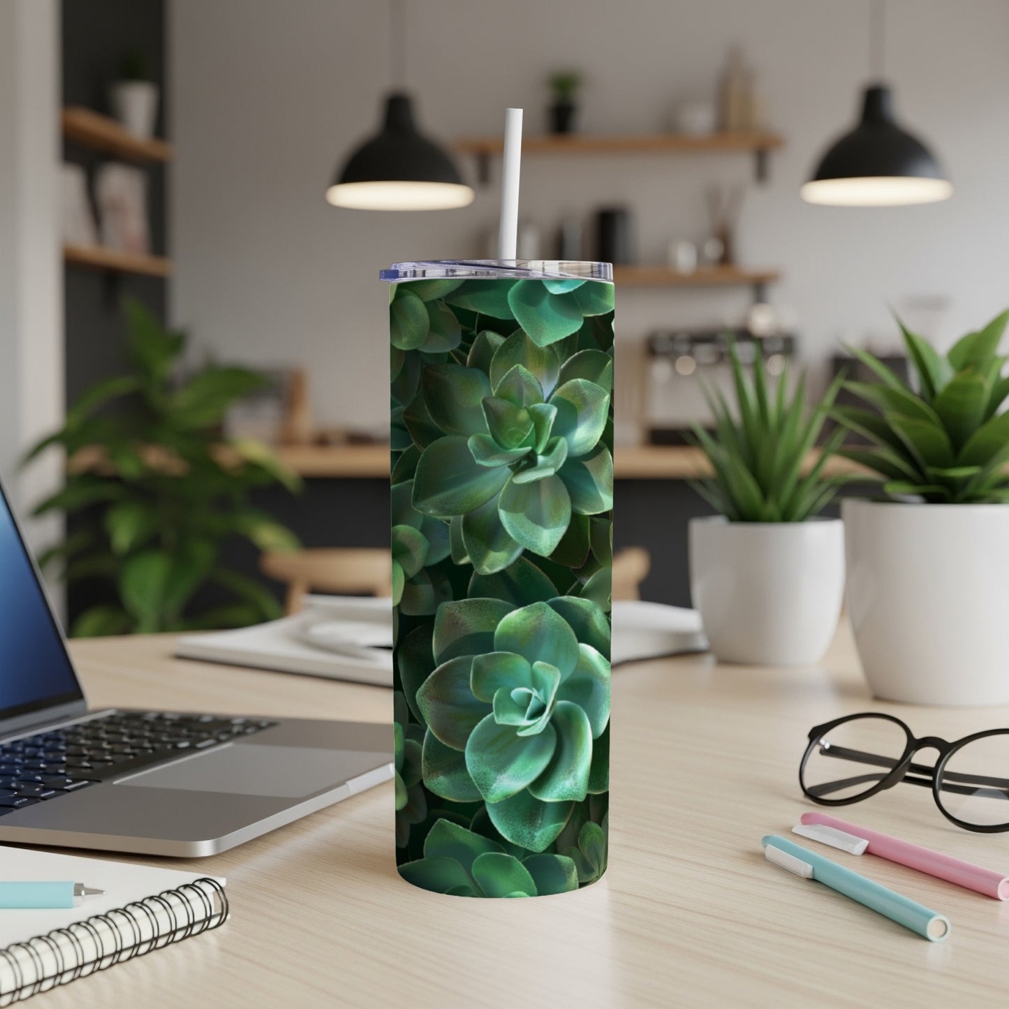 Green succulent pattern on a white tumbler with a straw.