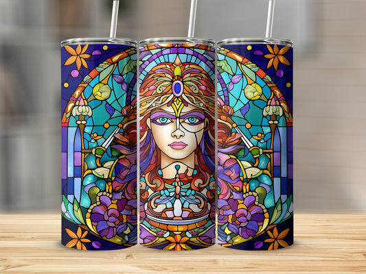 Stained glass art of a woman's face framed by colorful floral patterns and ornate designs.