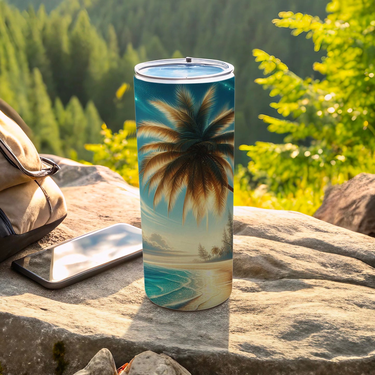 Tall tumbler with palm tree sunset beach scene, resting on rock near phone.