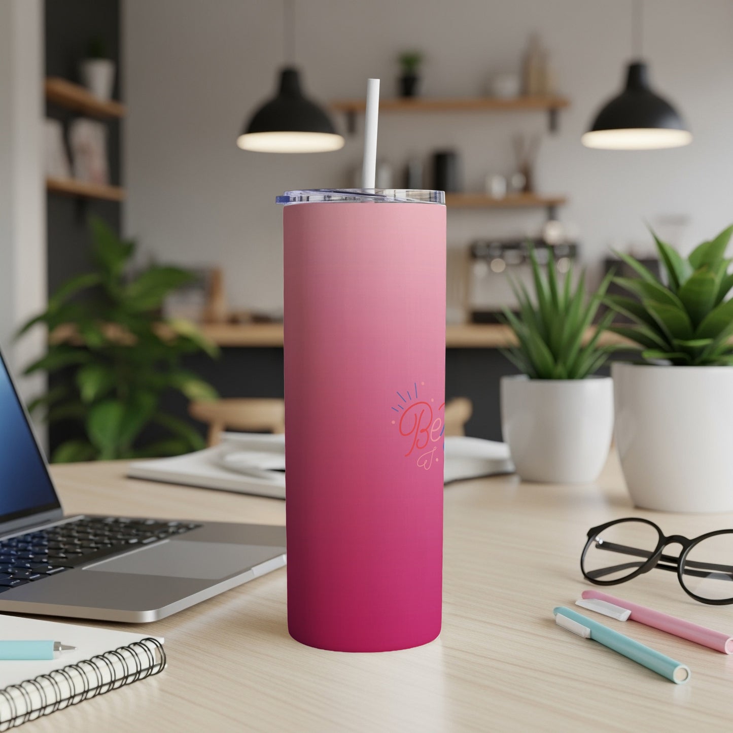 Pink ombre tumbler with "Bestie" text, on a desk with laptop and pens.