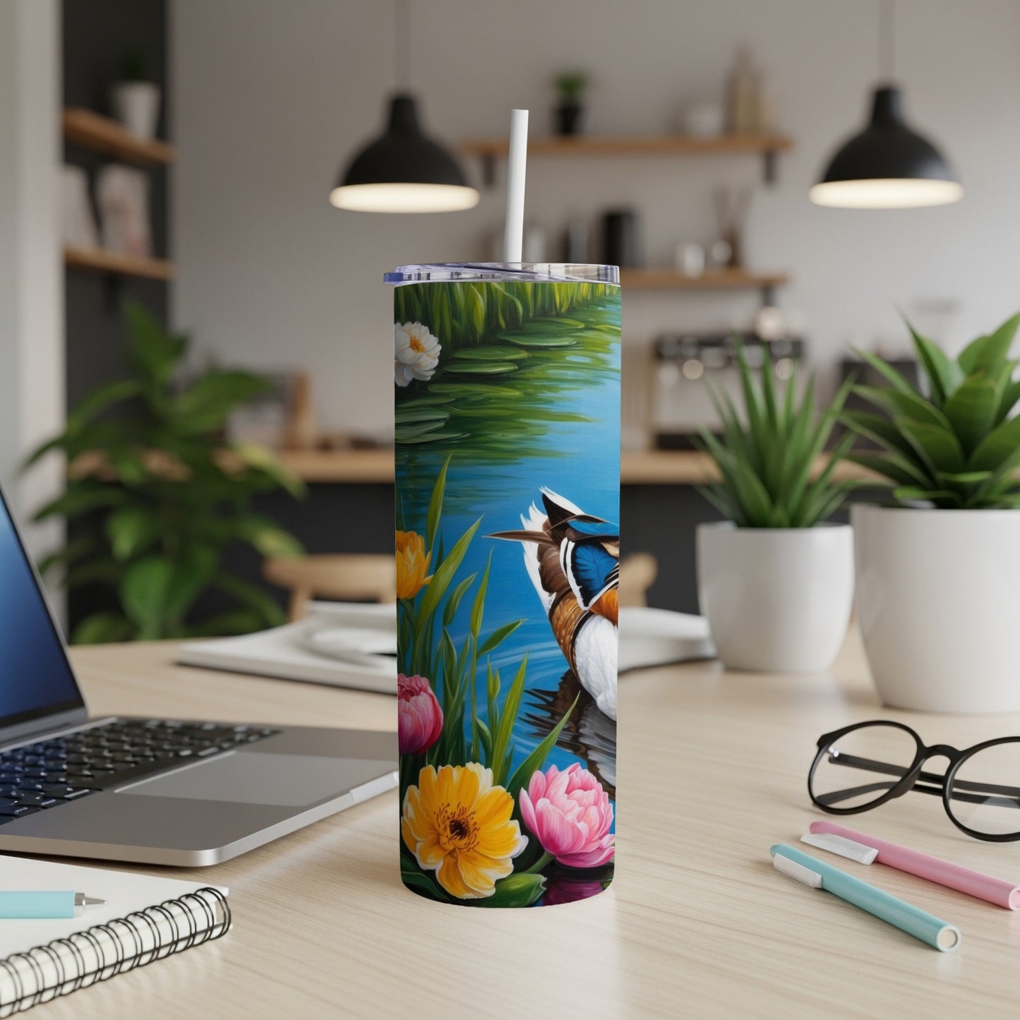 Tumbler with a duck and flowers on a watery background.