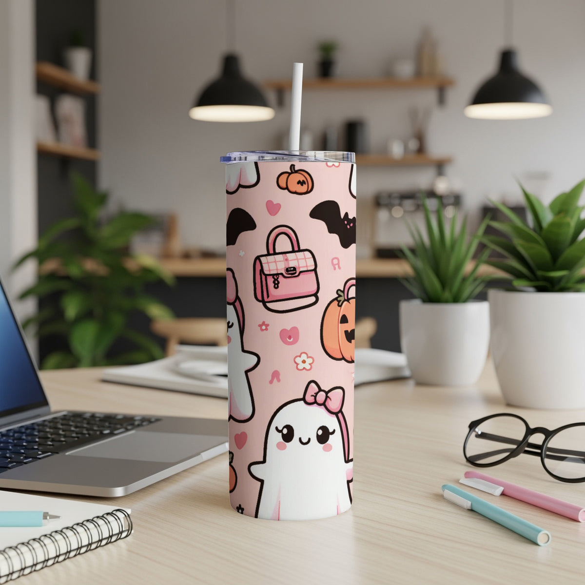 Pink tumbler with kawaii ghosts, bats, and pumpkins pattern.