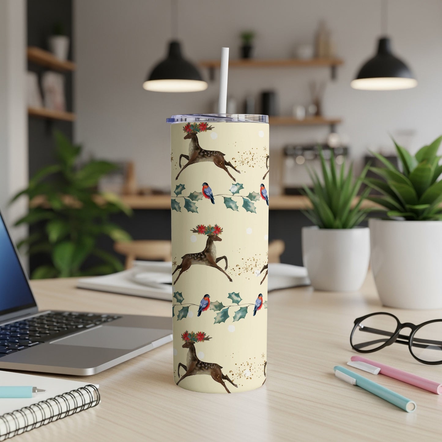 Cream tumbler with reindeer, holly, and birds pattern.
