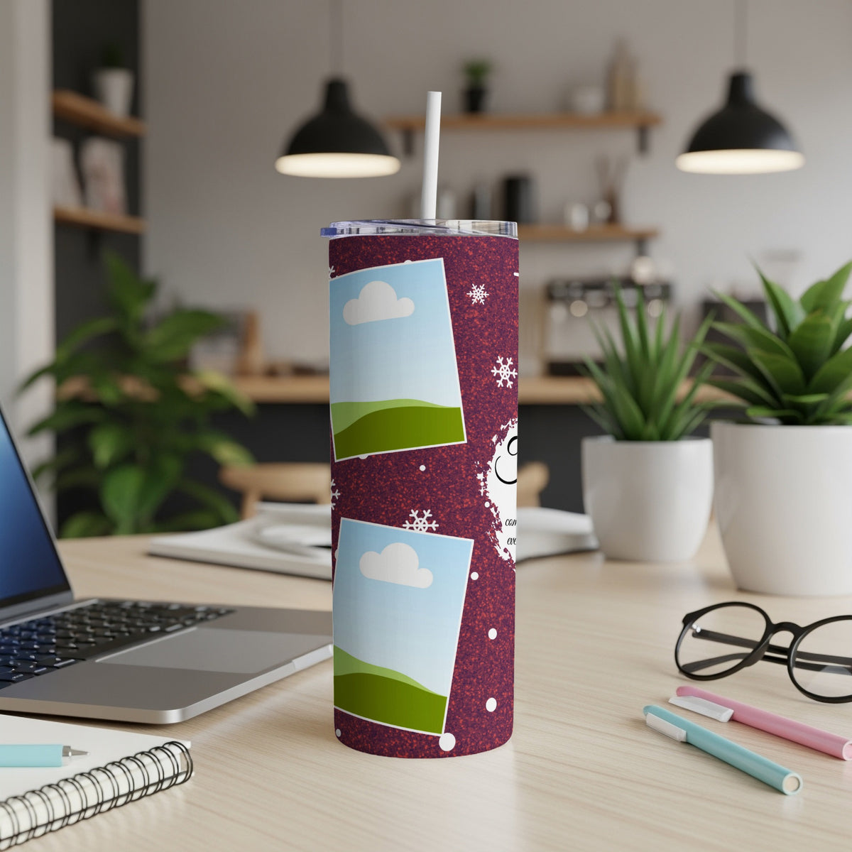 Tumbler with snowflakes and photo frames on a speckled maroon background.