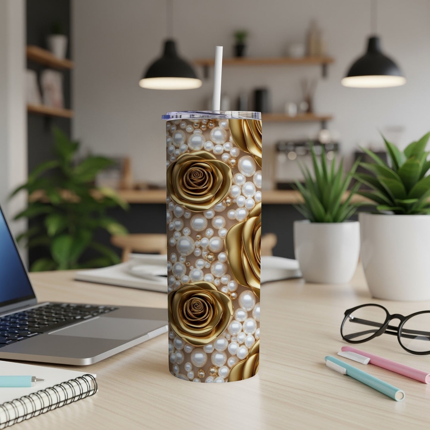 Gold roses and pearls on a white tumbler with a straw.