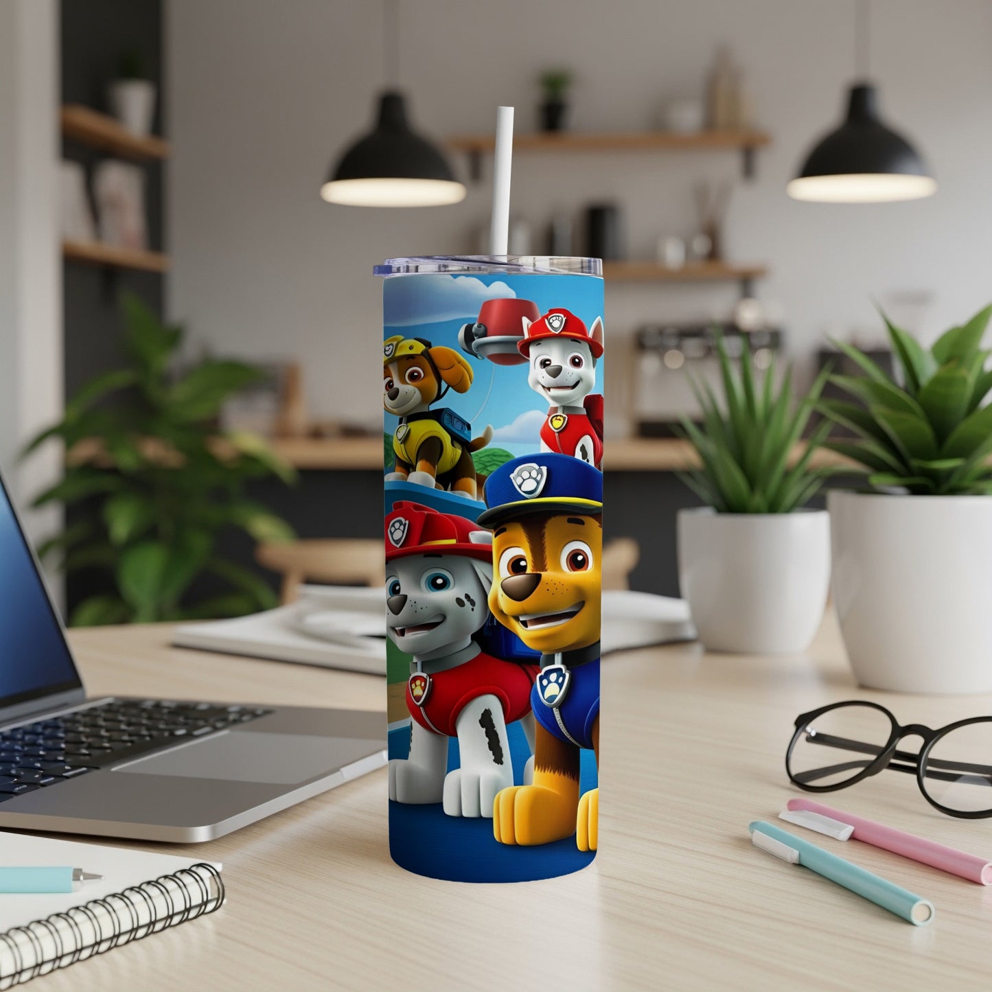 Paw Patrol characters Chase, Marshall, and Rubble on a blue tumbler with straw.