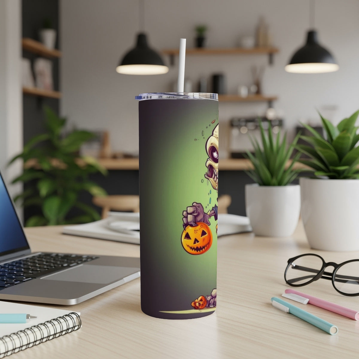 Tumbler with cartoon zombie holding a pumpkin on a green background.