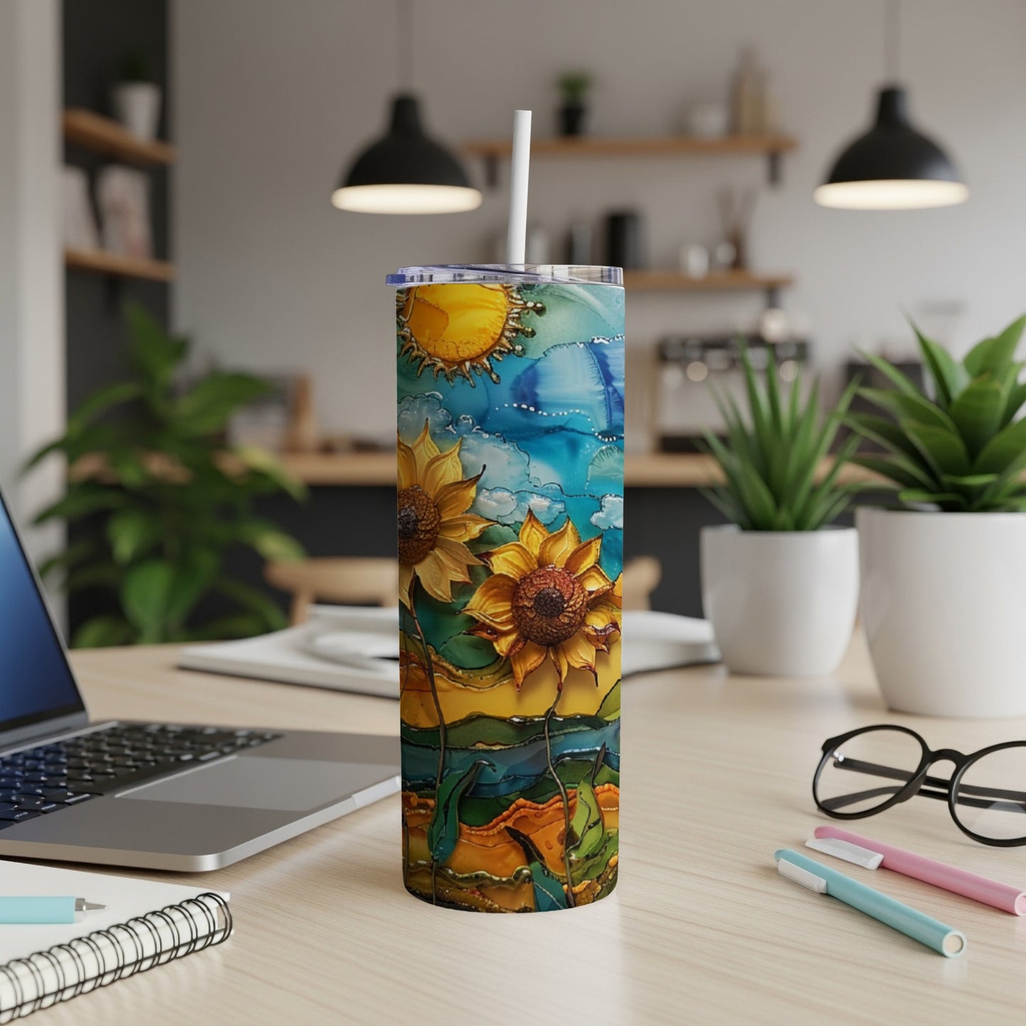 Tall tumbler with sunflowers and sun against a colorful, abstract sky.