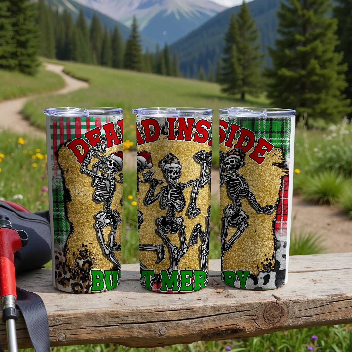 Three tumblers with "Dead Inside But Merry" text, skeleton graphics, and woodsy background.