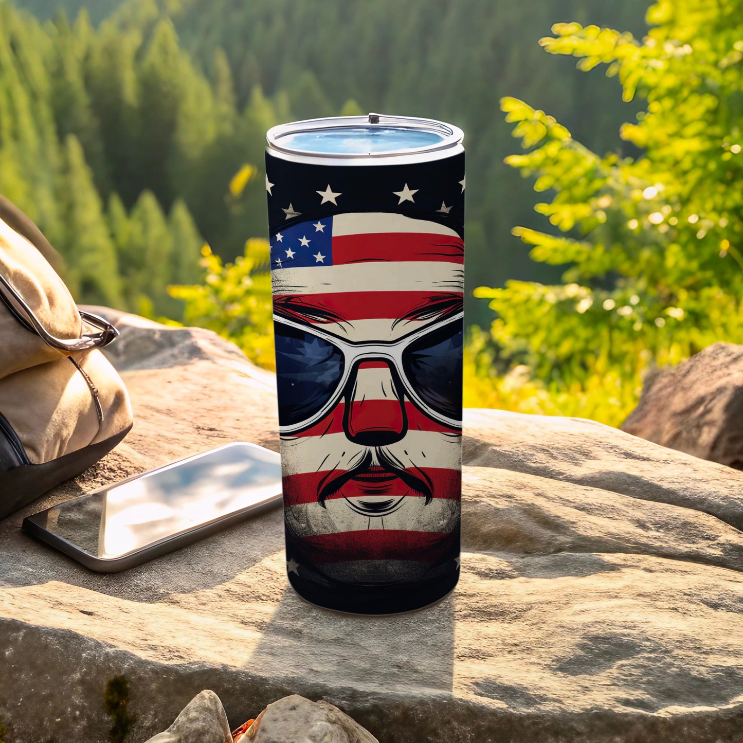 USA flag themed tumbler with sunglasses on a rock.